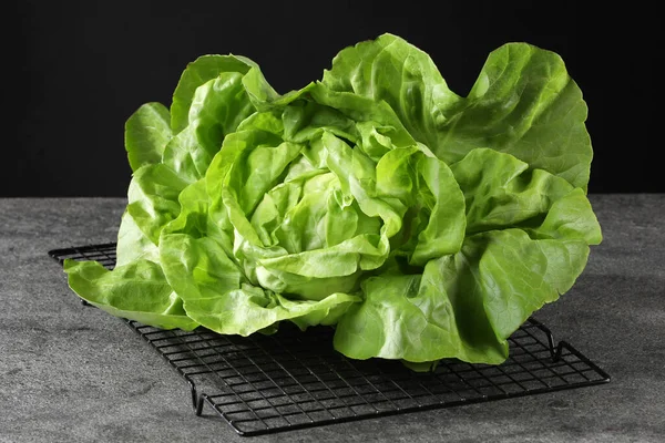 Fresh green butter lettuce on grey table