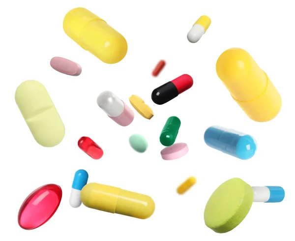 Mange Forskjellige Fargerike Piller Som Faller Hvit Bakgrunn – stockfoto
