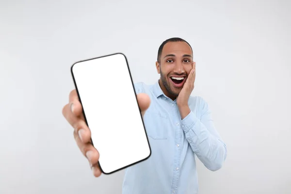 Překvapený Muž Ukazuje Smartphone Ruce Bílém Pozadí — Stock fotografie