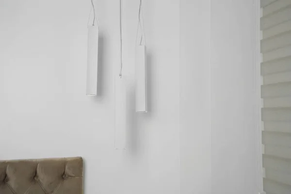 Stylish pendant lamps hanging in light room