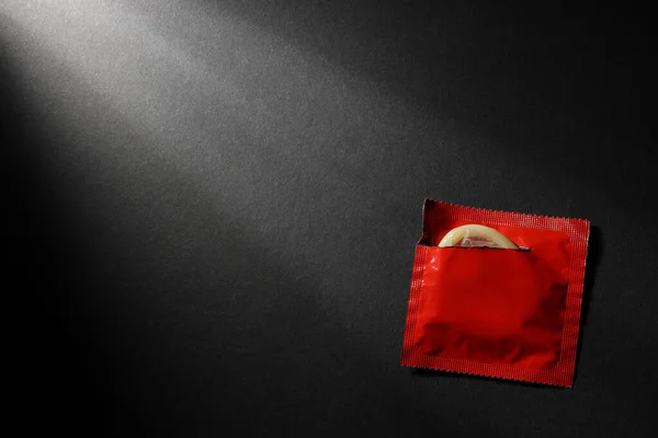 Condom Torn Package Black Background Top View Space Text Safe — Stock Photo, Image