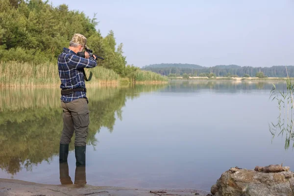 Hombre Apuntando Con Rifle Caza Cerca Del Lago Aire Libre — Foto de Stock
