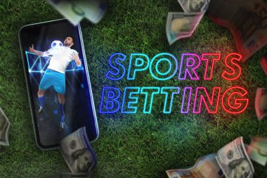 Bookmaking, sports betting. Mobile phone with football player on screen, dollars falling on green grass clipart