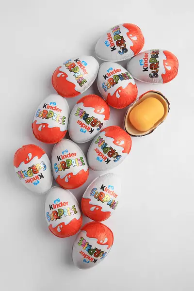 stock image Sveti Vlas, Bulgaria - June 26, 2023: Kinder Surprise Eggs and plastic capsule with toy on white background, flat lay