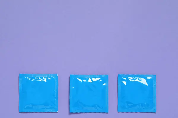 Condom Packages Purple Background Flat Lay Space Text Safe Sex — Stock Photo, Image