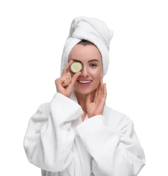 Schöne Frau Bademantel Bedeckt Auge Mit Stück Gurke Auf Weißem — Stockfoto
