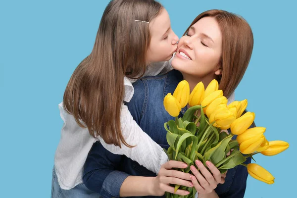 Matka Její Roztomilá Dcera Kyticí Žlutých Tulipánů Světle Modrém Pozadí — Stock fotografie