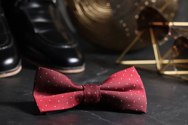 Stylish red bow tie on black background