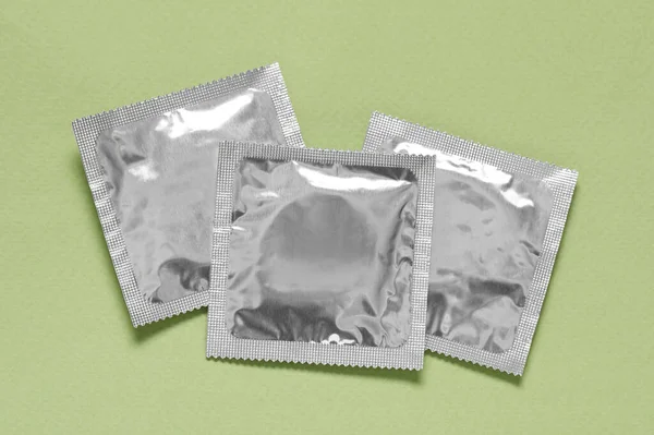 Condom Packages Light Green Background Flat Lay Safe Sex — Stock Photo, Image