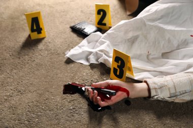 Crime scene with dead woman's body, bloody knife and markers outdoors, closeup clipart