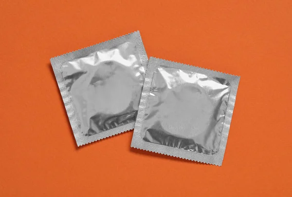 Condom Packages Orange Background Flat Lay Safe Sex — Stock Photo, Image