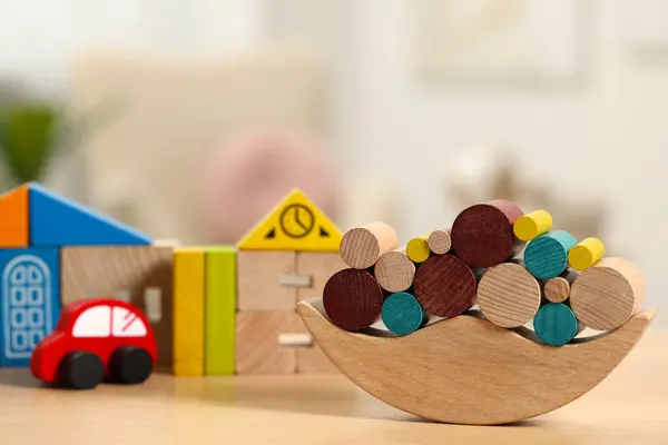 Wooden balance toy on table, closeup. Space for text. Children\'s development