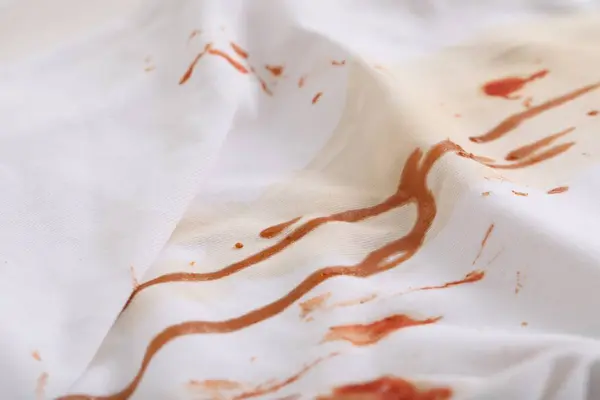 White shirt with stain of sauce, closeup