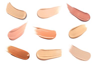 Beyazda izole edilmiş çeşitli deri tipleri için farklı dokuların ve tonların temeli. Makyaj ürünü örnekleriyle ayarlandı