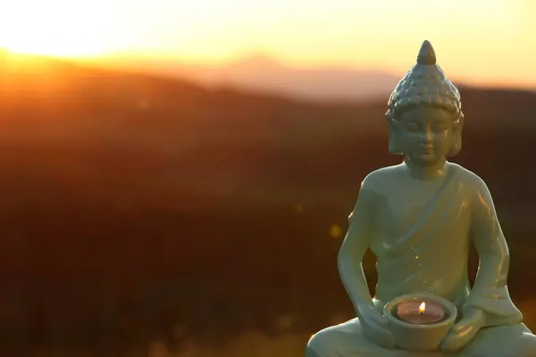 Decorative Buddha Statue Burning Candle Mountains Sunset Space Text — Stock Photo, Image