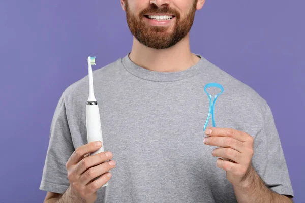 Man Tongue Cleaner Electric Toothbrush Violet Background Closeup Stock Image