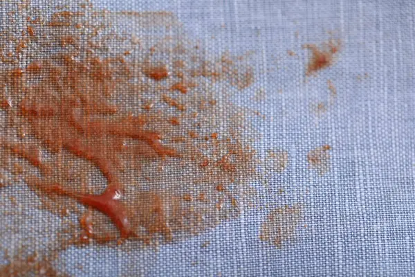 Denim shirt with stain of sauce, closeup