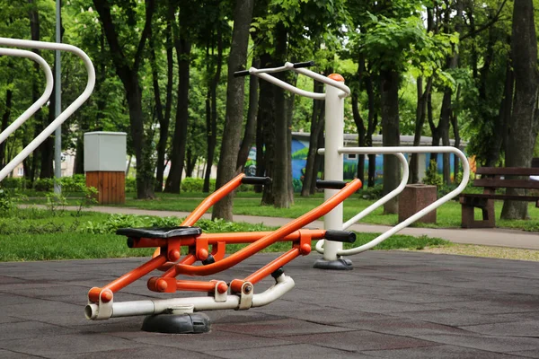 Empty outdoor gym with push up bars and rowing machine