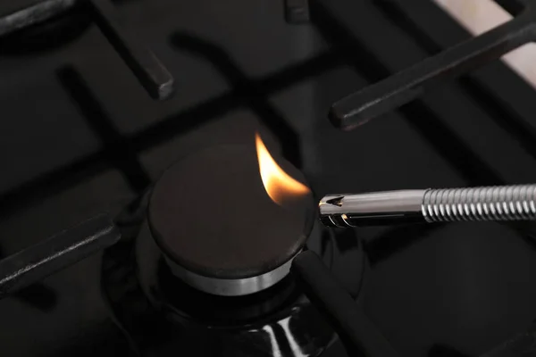 stock image Lighting stove with gas lighter, closeup view