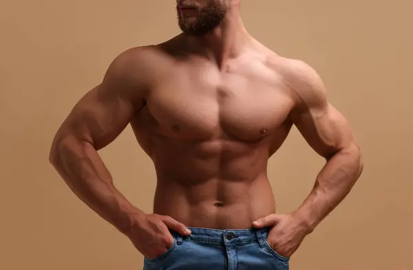 Muskularny Mężczyzna Pokazuje Mięśnie Brzucha Beżowym Tle Zbliżenie Sexy Ciało — Zdjęcie stockowe