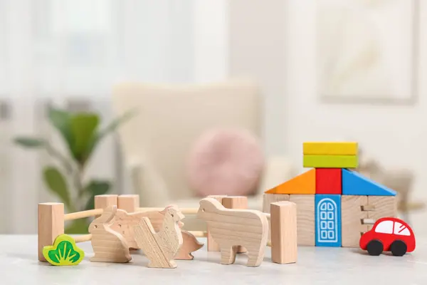 Set of wooden toys on light grey table indoors. Children\'s development