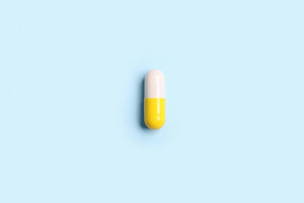 One Pill Light Blue Background Top View — Stock Photo, Image