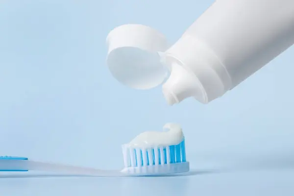Applying Paste Toothbrush Light Blue Background Closeup — Stock Photo, Image