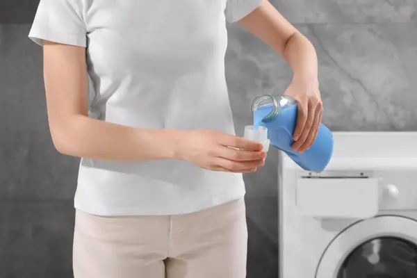 Woman Pouring Fabric Softener Bottle Cap Washing Machine Indoors Closeup — Stock Photo, Image