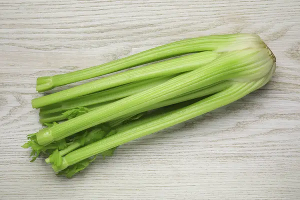 One Fresh Green Celery Bunch White Wooden Table Top View — Stock Photo, Image