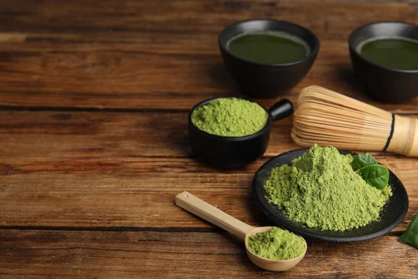 Composition with green matcha powder on wooden table, space for text