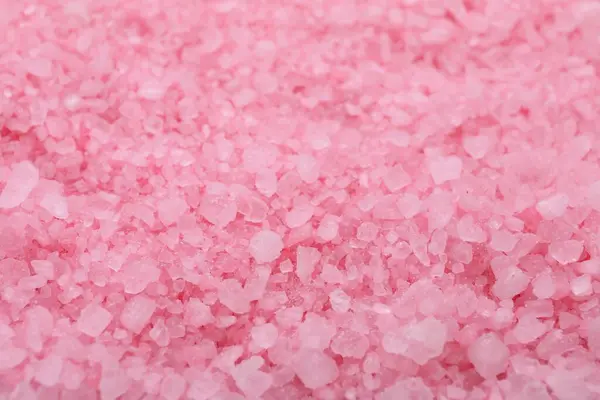 Pink sea salt as background, closeup view