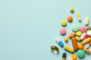 Açık mavi arka planda bir sürü farklı hap var. Metin için boşluk