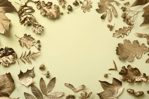 Frame made of different golden leaves on beige background, flat lay with space for text. Autumn decor