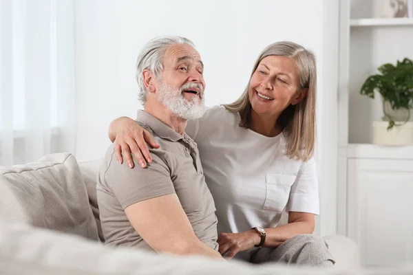 stock image Happy senior couple relaxing on sofa at home