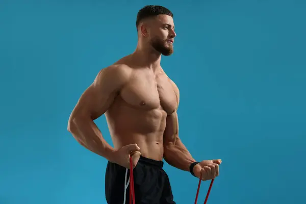 Uomo Muscolare Esercizio Con Elastico Elastico Resistenza Sfondo Azzurro — Foto Stock