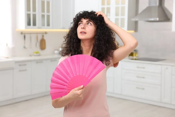 Young Woman Waving Pink Hand Fan Cool Herself Kitchen — Stock Photo, Image