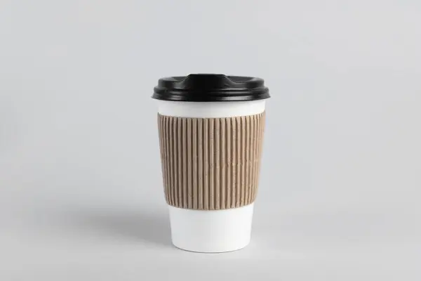 Paper cup with plastic lid on light background. Coffee to go