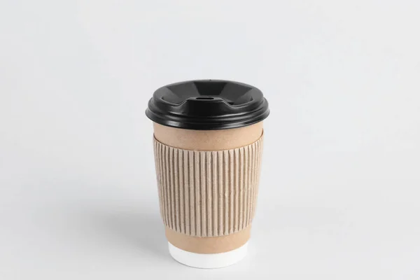 Paper cup with plastic lid on light background. Coffee to go