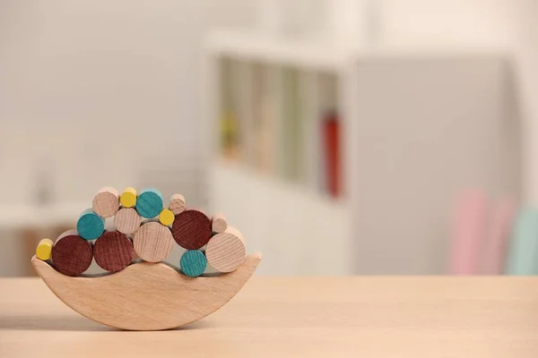Wooden balance toy on table indoors, closeup. Space for text. Children's development
