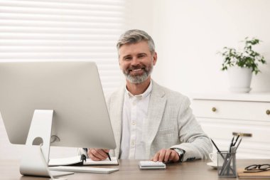 Ofisteki ahşap masada çalışan profesyonel muhasebeci.