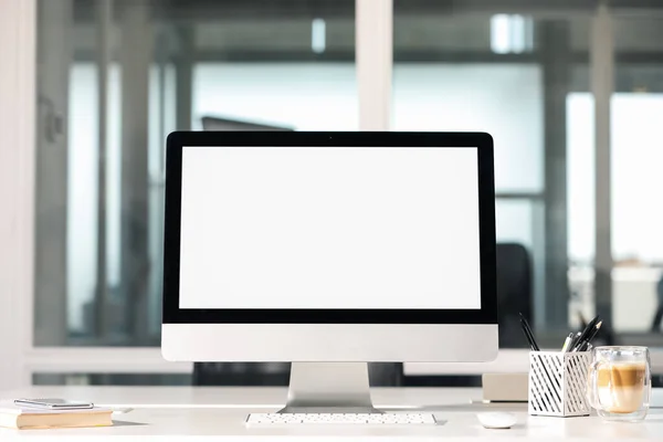 Modern computer on white desk in office. Mockup for design