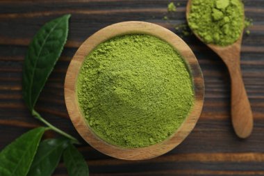 Tabak ve kaşık yeşil kibrit tozu ile ahşap masa, düz yatıyordu