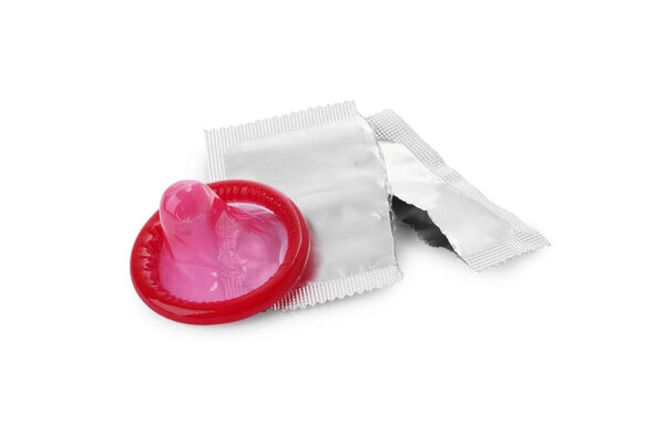 Unpacked condom and torn package on white background. Safe sex