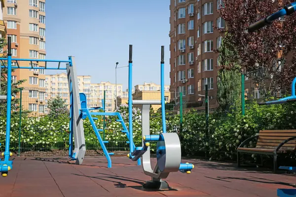 Empty outdoor gym with air walker and monkey bars in residential area