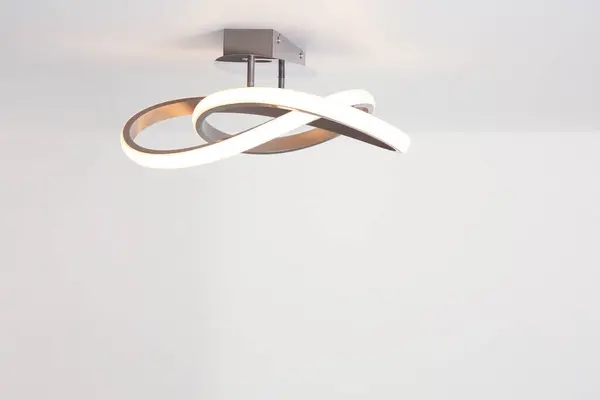 White ceiling with stylish lamp in room. Space for text