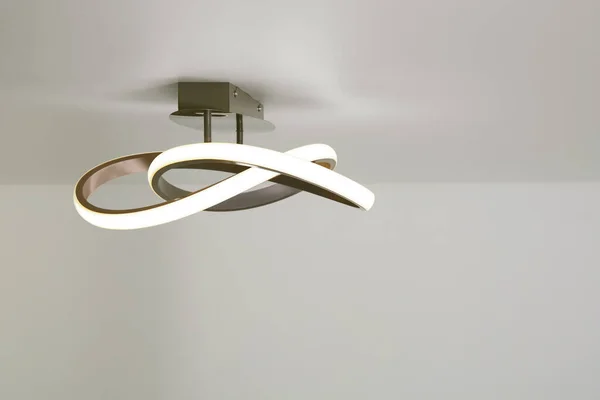 White ceiling with stylish lamp in room. Space for text