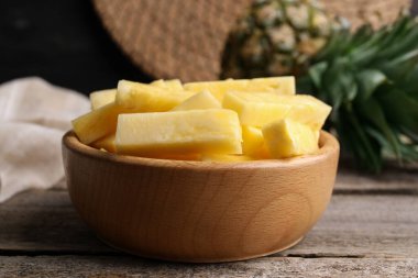 Lezzetli olgun ananas parçaları ahşap masada, yakın plan.