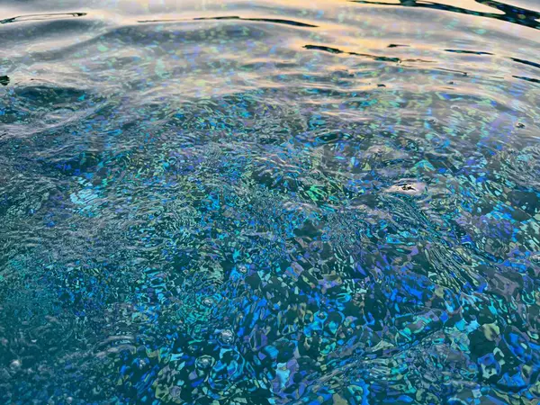 Clear rippled water in outdoor swimming pool