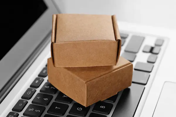Mini boxes on laptop, closeup. Online store