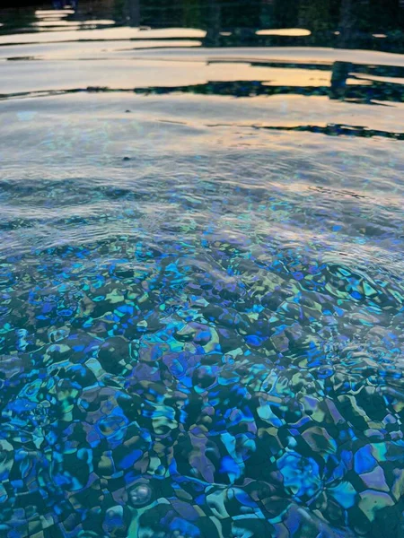 Clear rippled water in outdoor swimming pool